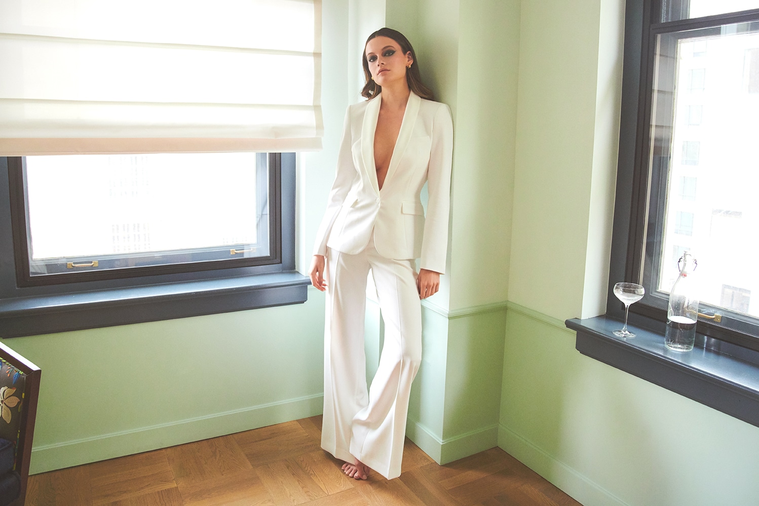 White suit editorial, green room, champagne coupe