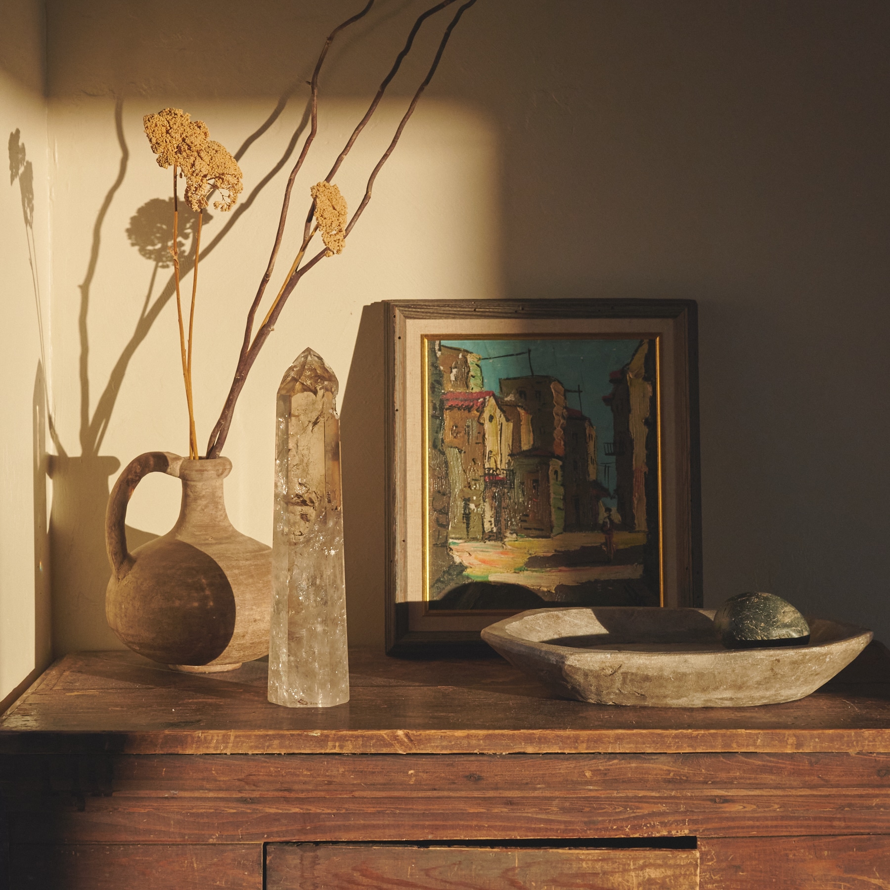 Crystal point with vintage painting, ceramic vase, dried flowers