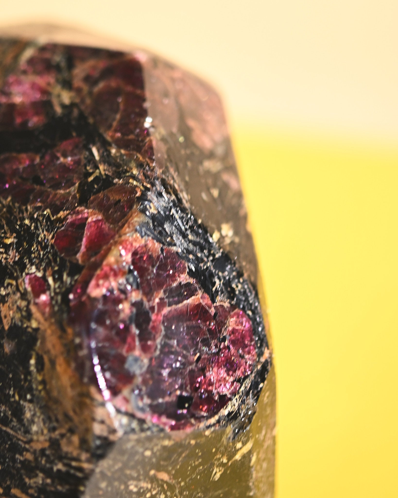 Garnet freeform, deep red rhodolite crystals in matrix, macro detail
