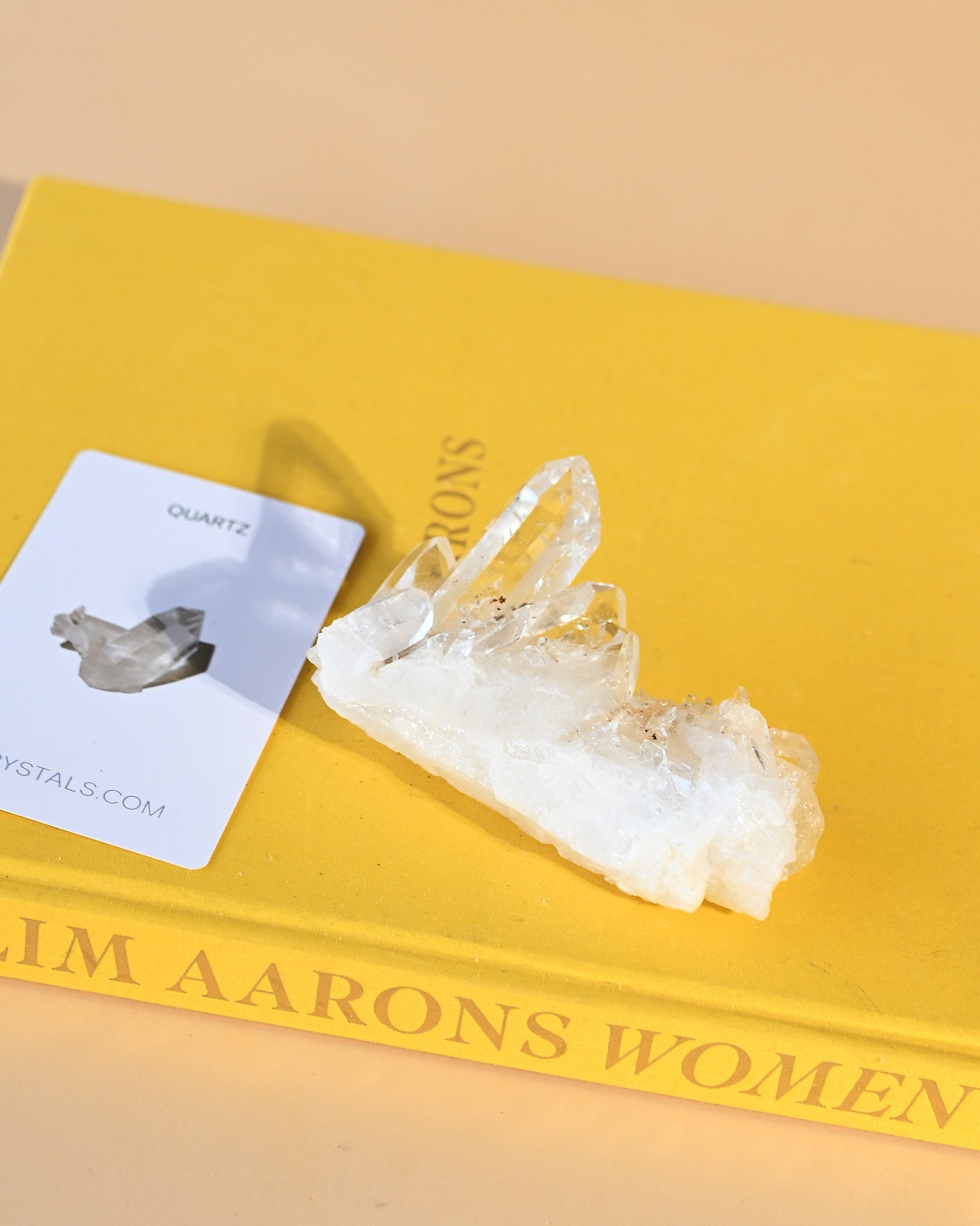 Lemurian quartz cluster on Slim Aarons book, Crystals.com card