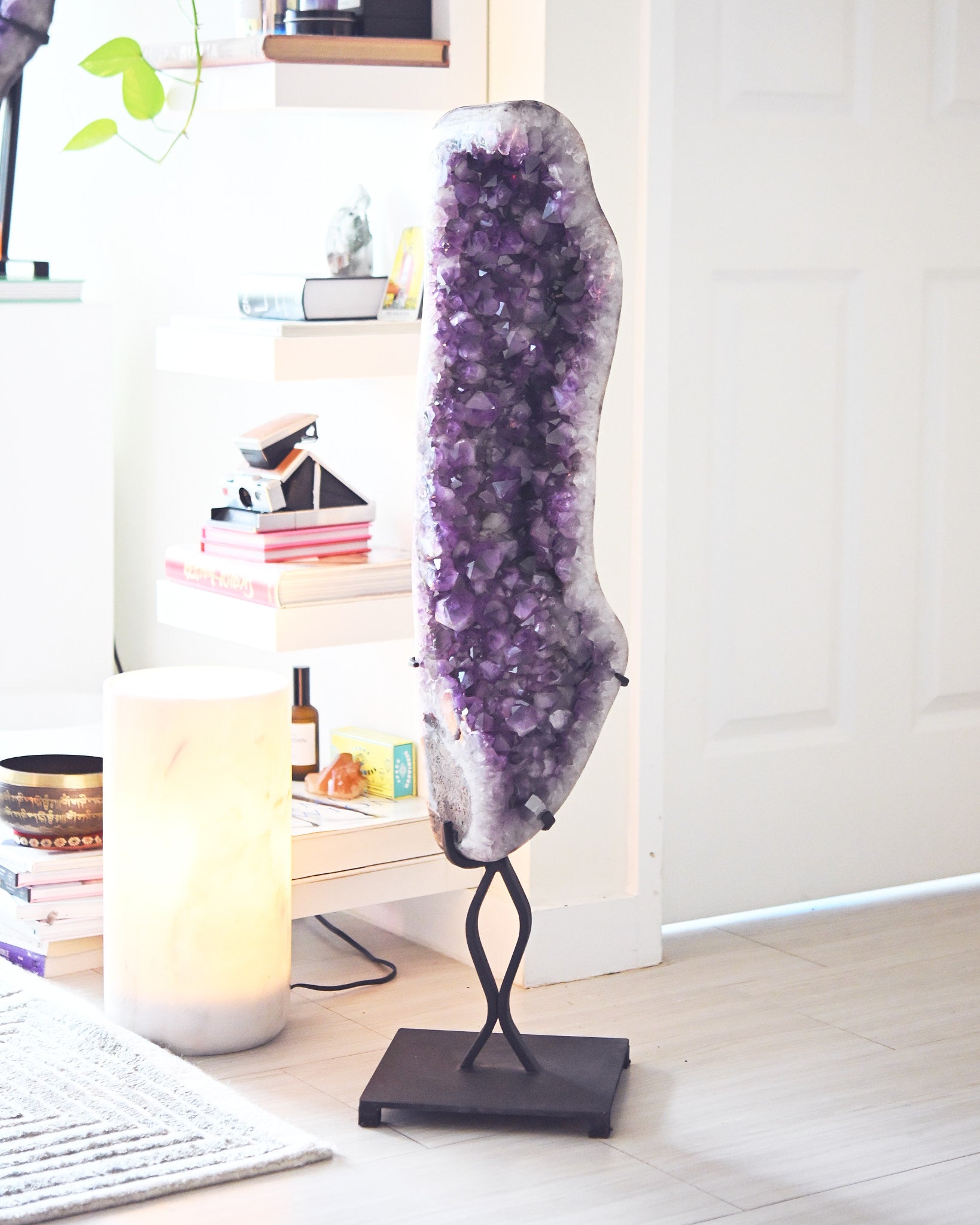 Statement amethyst cathedral on stand, studio with books and onyx lamp