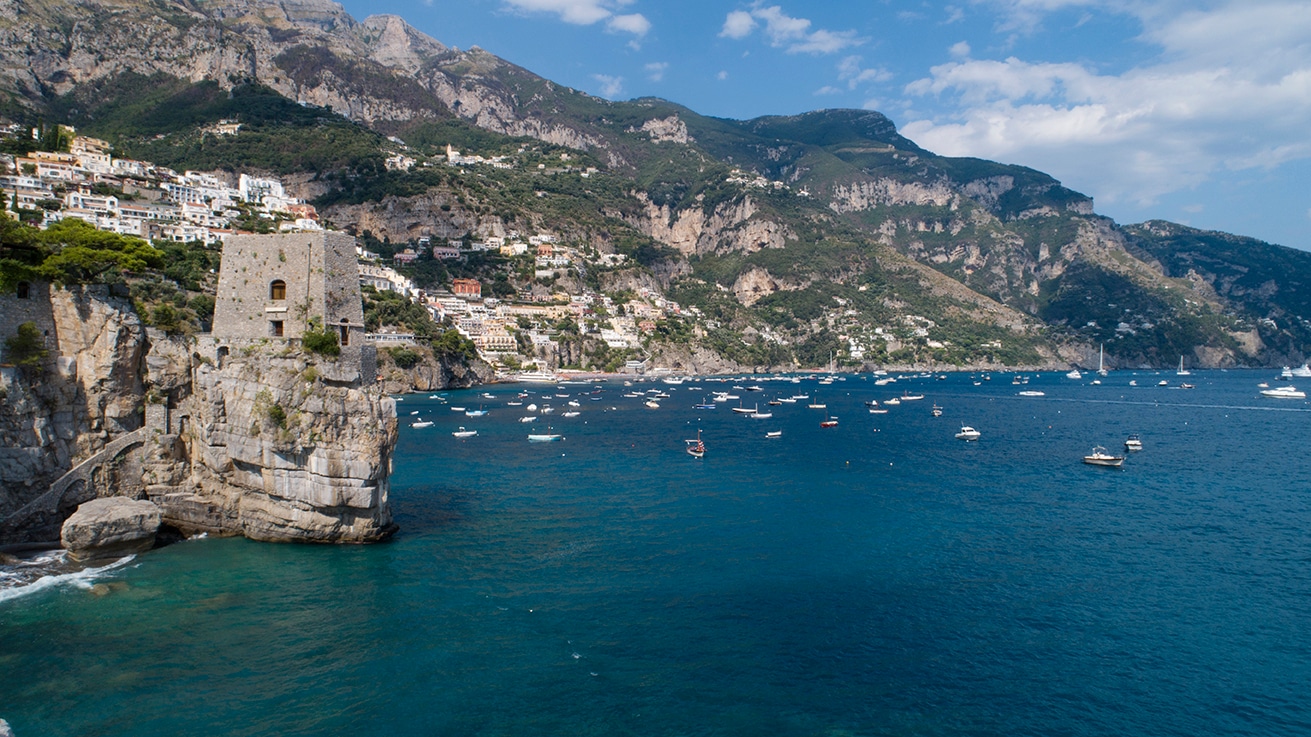 Aerial drone, Italian coastline, turquoise water meeting rocky cliffs