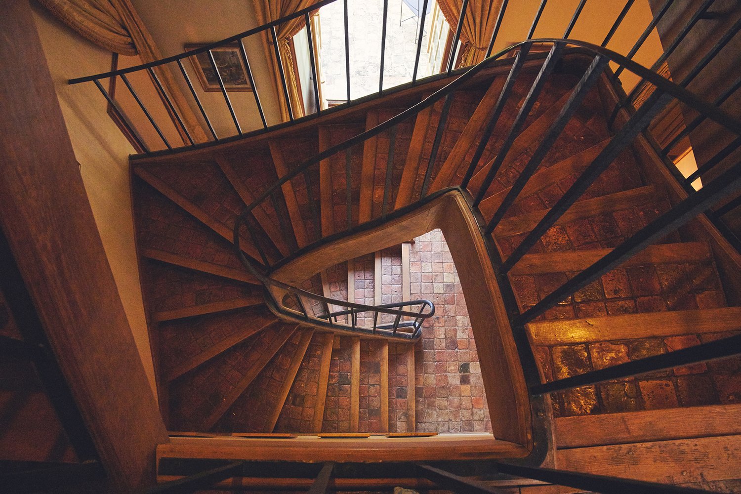 Spiral staircase, warm wood, looking down