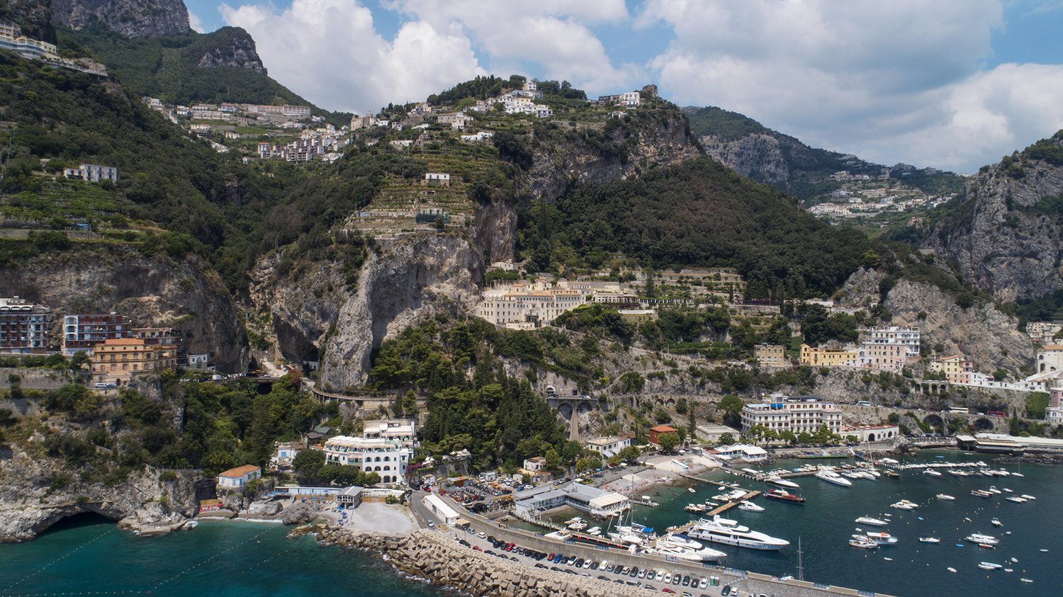 Amalfi harbor aerial, yachts, turquoise bay, cathedral dome