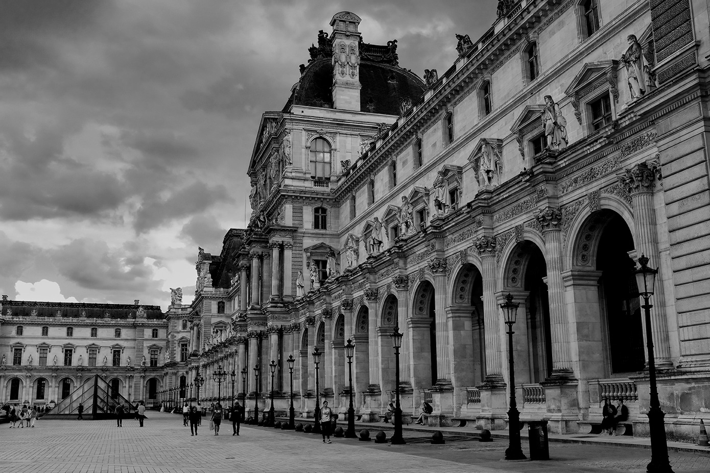 Louvre wing in black and white, dramatic storm clouds, Beaux-Arts arches and lamp posts