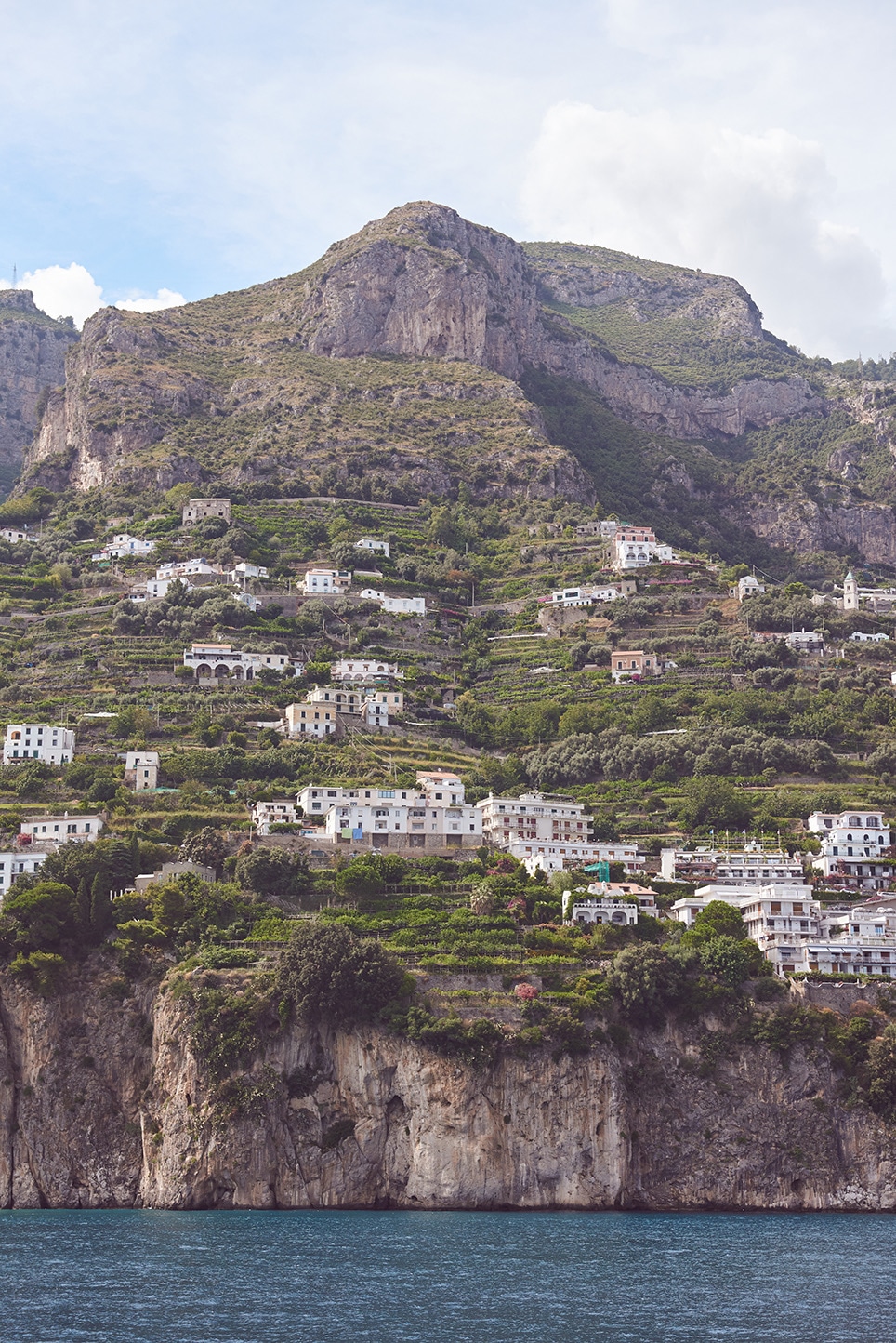 Amalfi Coast terraced hillside village, white villas in green cliffs