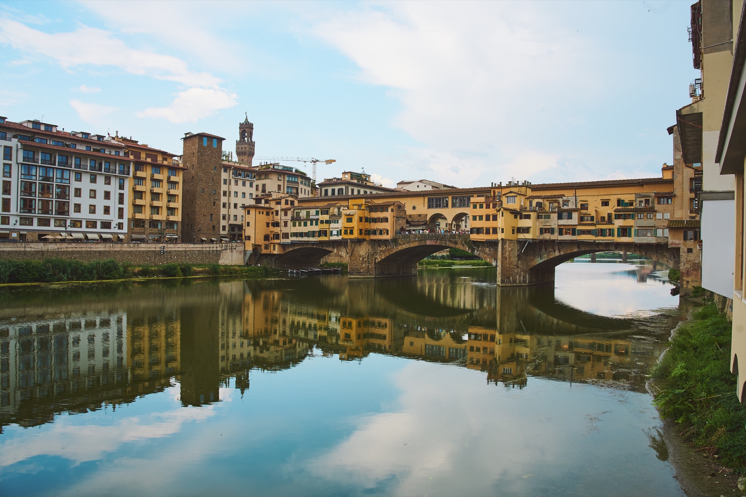 Florence Ponte Vecchio reflected in the Arno at golden hour