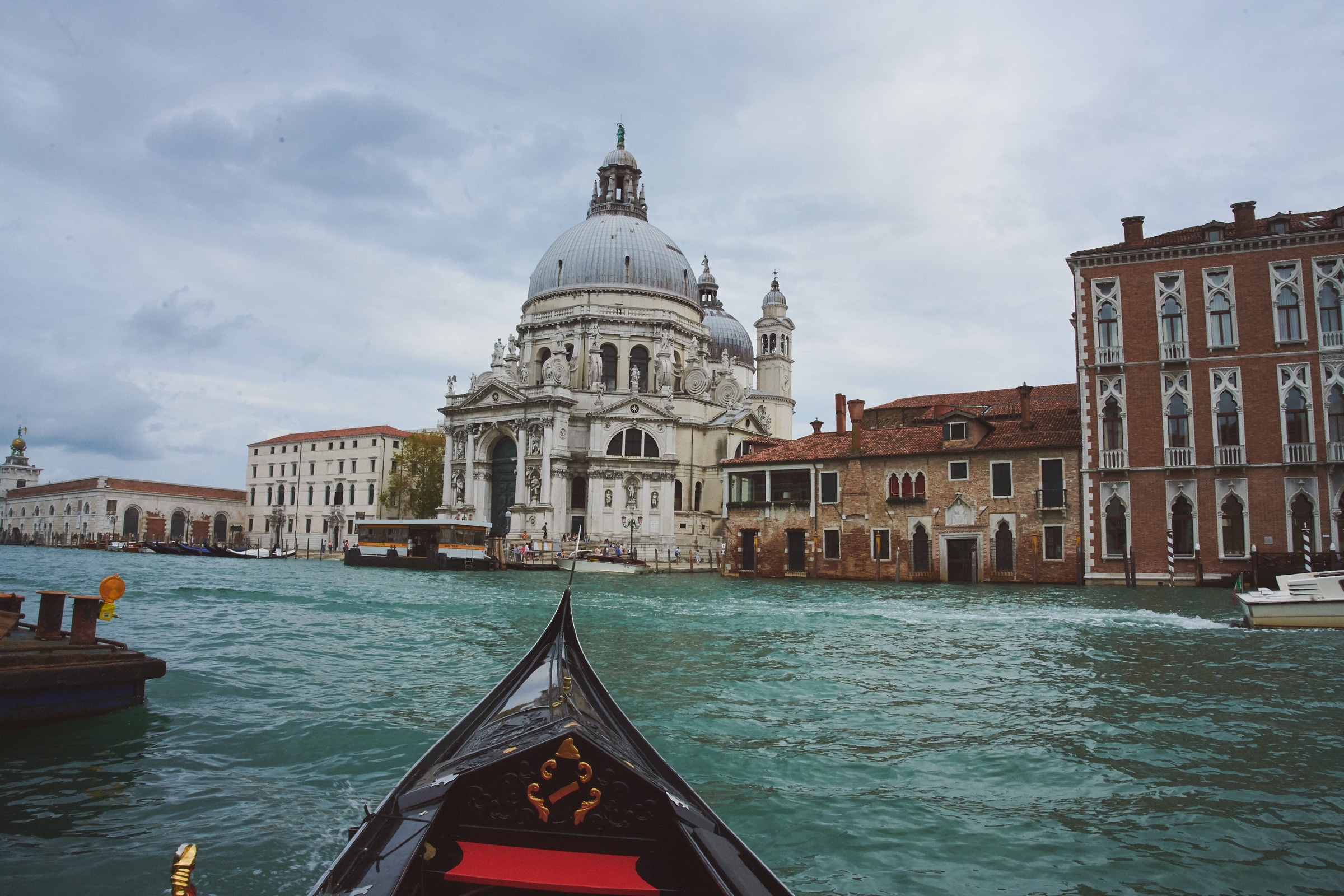 Venice gondola approaching Santa Maria della Salute, golden light on Grand Canal