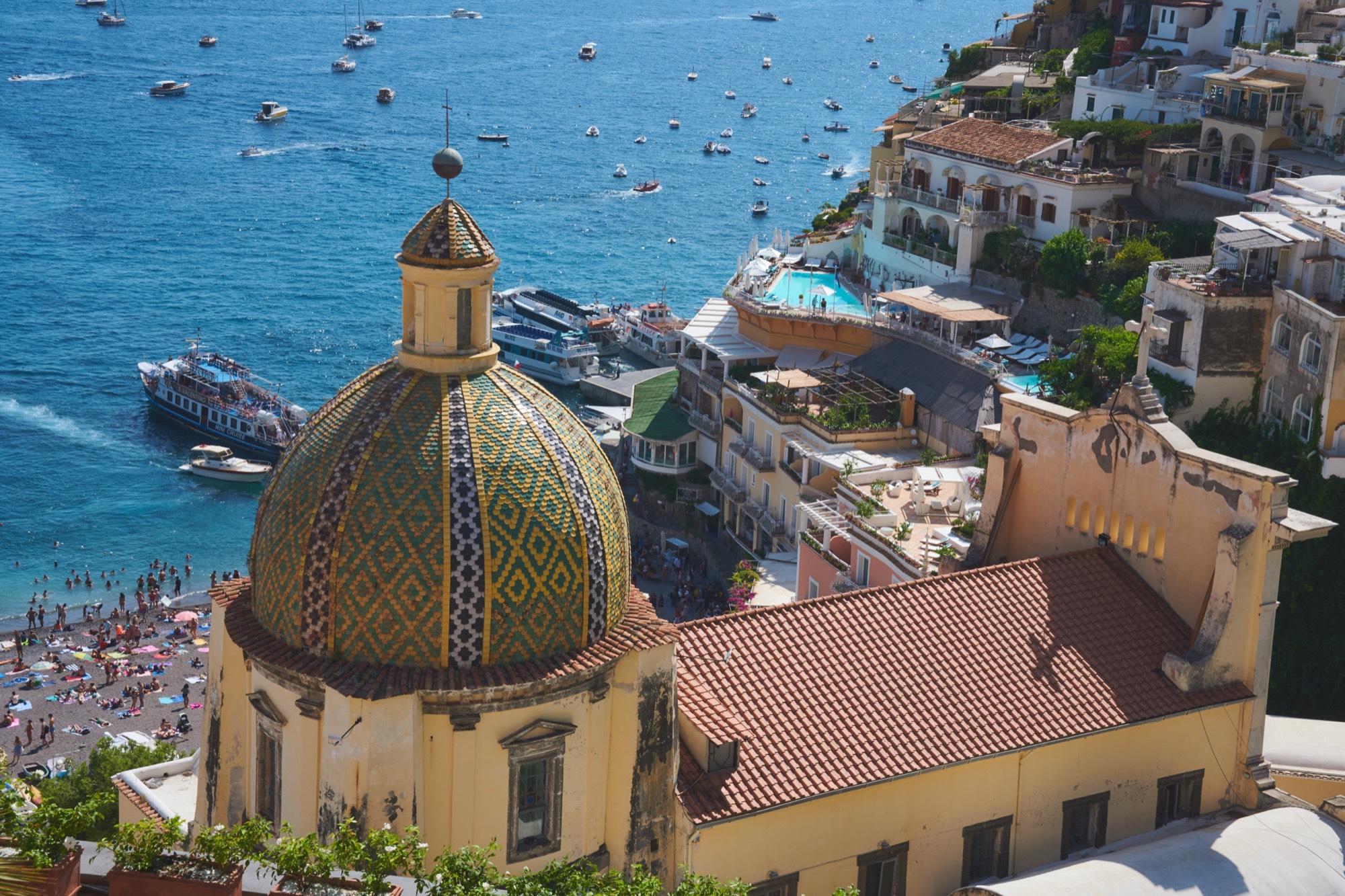 Positano majolica dome from above, fishing boats in harbor, Amalfi Coast