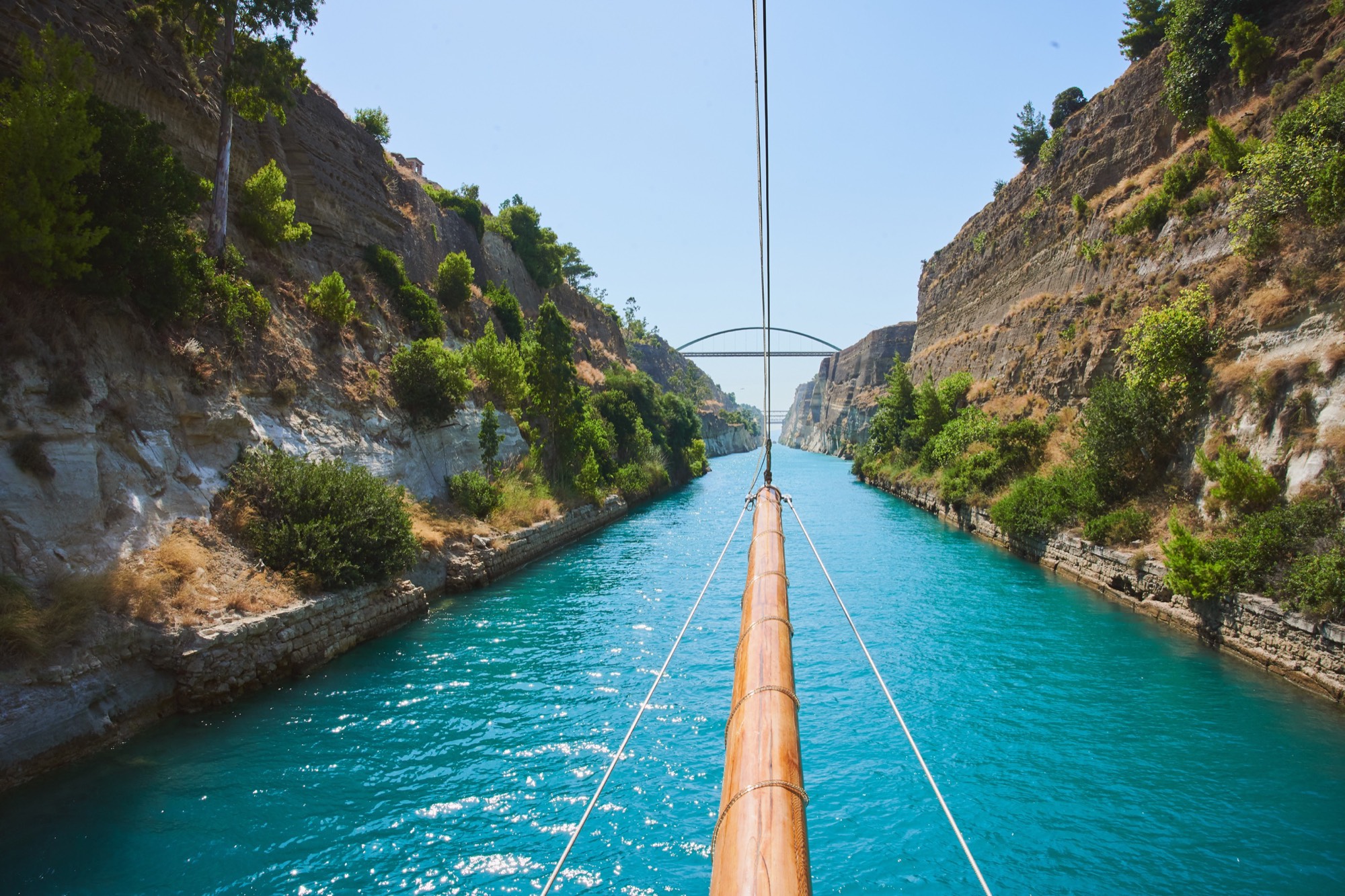 Corinth Canal from the bow, turquoise water cutting through limestone cliffs